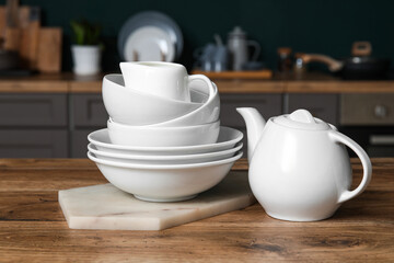 White dishes on table in kitchen, closeup