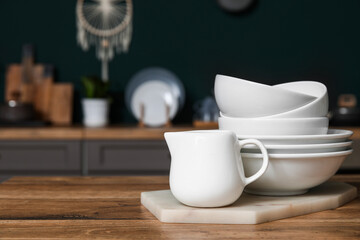 White dishes on table in kitchen, closeup