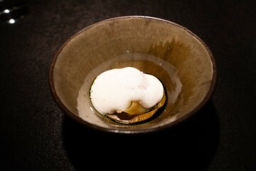 white liquid on top of appetizer at fine dining restaurant