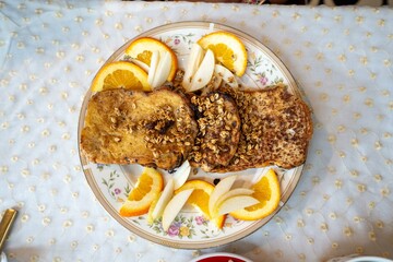 french toast with many sliced fruits throughout plate at tasty and organic breakfast restaurant during the morning