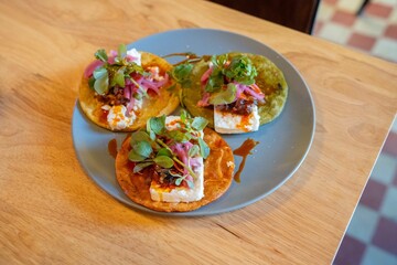 close up of colorful and delicious open faced tacos at fine dining mexican restaurant during the day
