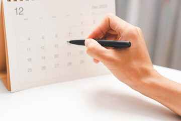 Event planner timetable agenda plan on year 2024 schedule event. Business checking planner on mobile phone, taking note on calendar desk on office table. Calendar event plan, work planning