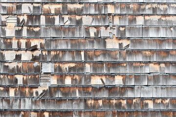 Cedar shake siding worn and tattered. 