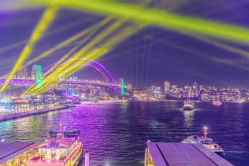 Colourful Light show at night on Sydney Harbour NSW Australia. The bridge illuminated with lasers...