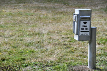 Pay box at state campground. Metal box mounted to pole.
