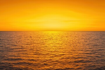Obraz premium A golden sunset over a vast ocean, casting a warm glow, golden sunset, natural beauty