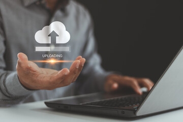 Upload processing data concept. Uploading data to cloud storage. The person using a laptop with an...