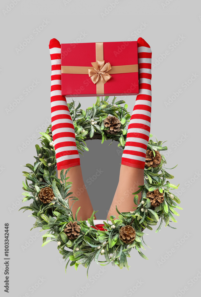 Canvas Prints Sexy young woman in Christmas stockings and with gift on light background