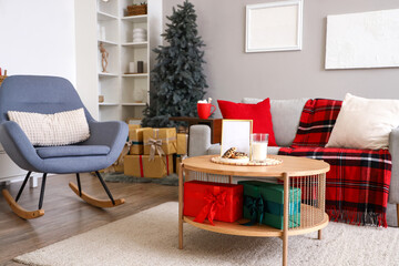 Interior of living room decorated for Christmas with sofa and table