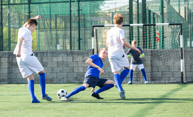 Teens playing soccer football match. Competition between two youth soccer teams. Football soccer...