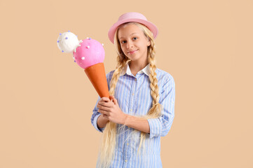 Happy teenager girl with toy in shape of ice cream on beige background