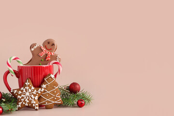Composition with cup, fir tree branches, tasty cookies and Christmas balls on light background