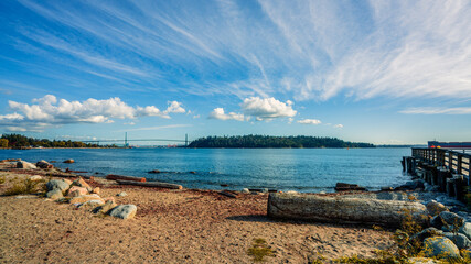 View from beach at Ambleside, West Vancouver, BC, to Stanley Park with Lionsgate Bridge visible on left horizon.