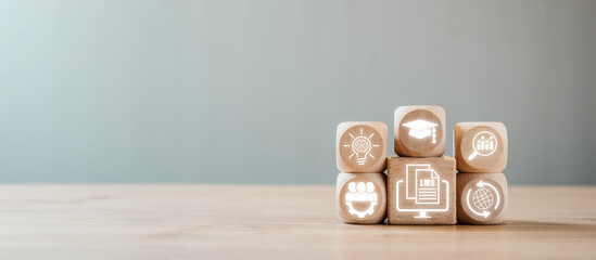 Wooden blocks with digital icons symbolizing a learning management system, showcasing education, technology, and online learning concepts.