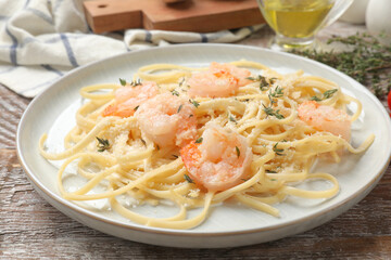 Delicious pasta with shrimps on wooden table, closeup