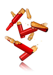 Many ampoules and glass pieces falling on white background