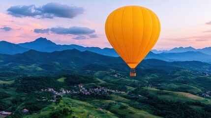 Fototapeta premium Hot Air Balloon Soaring Over Lush Green Mountains at Sunset