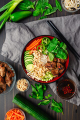 Bun Thit Nuong Vietnamese Grilled Pork with Nuoc Cham: Chunks of pork over vermicelli noodles with fresh herbs, peanuts, cucumber, and pickled carrots