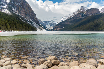 Incredible nature views at Lake Louise in world famous Alberta during spring time with partially...