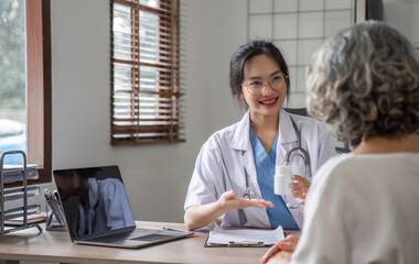 Young Female Doctor Advising Elderly Patient in Modern Clinic Setting, Discussing Medication and Health Care Options