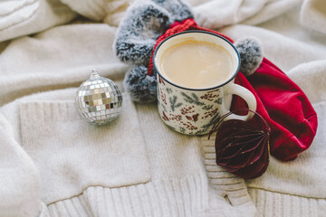 Cozy winter setting with drink, holiday gifts, and festive decorations