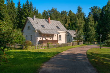 View of residential buildings on the territory of the Mikhailovskoye estate of the Pushkin State Museum-Reserve on a sunny summer day, Pushkinskiye Gory, Pskov region, Russia