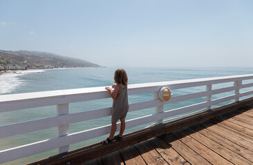 boy looking at ocean from Malibu Pier