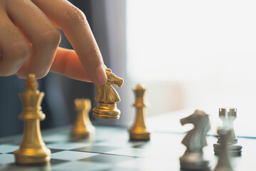 Businessman planning strategy with chess figures, leadership assignment concept.