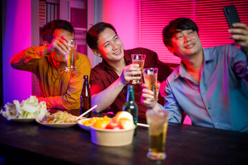 In a late-night office party, a group of Asian men gathers with beer glasses, surrounded by stacks of paper, celebrating and unwinding after a long workday, blending fun and professionalism.