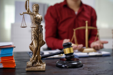 close-up of a lawyer’s hands working at a desk, reviewing legal documents and contracts, with a...