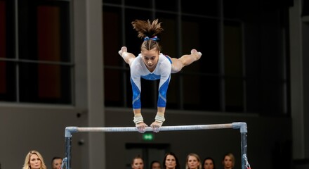 Female gymnast performing a handstand on the uneven bars.