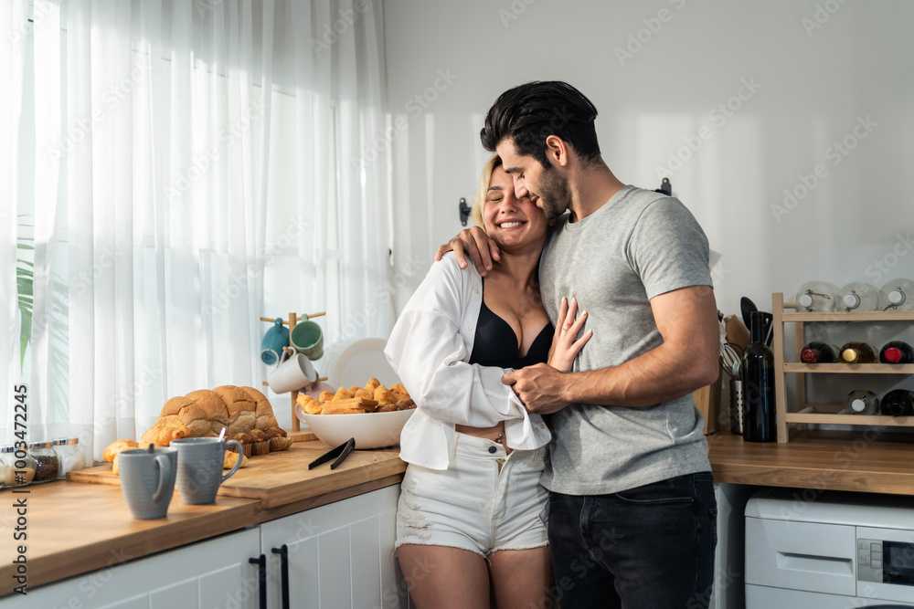 Wall mural caucasian young hot sexy couple baking bakery foods in kitchen at home.