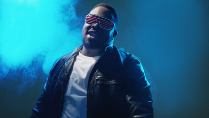 Rap performance. 90s party. Nightclub event. Cool stylish confident man in futuristic sunglasses...