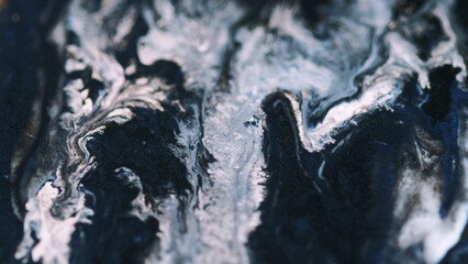 Liquid marble. Glitter paint drip. Defocused blue white black shimmering dye spill oil texture...