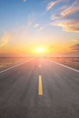 Asphalt highway road and desert with beautiful sky clouds natural landscape at sunset. Road trip.