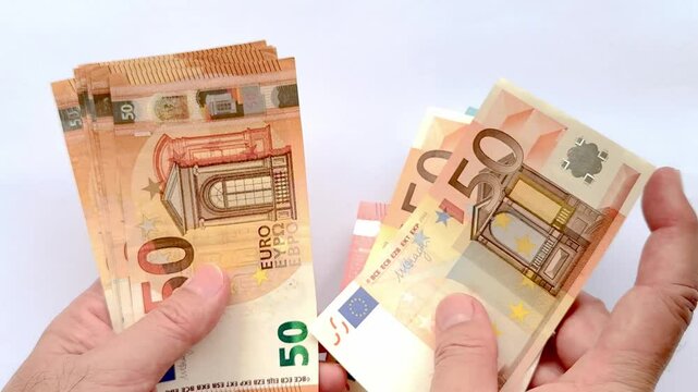 4K footage of hands and fingers counting Euro Money from the nominal of 50 Euro to 20 and 10 Euro. Hands counting Euro banknotes isolated on white background.
