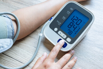 A man check blood pressure monitor and heart rate monitor with digital pressure gauge. Health...