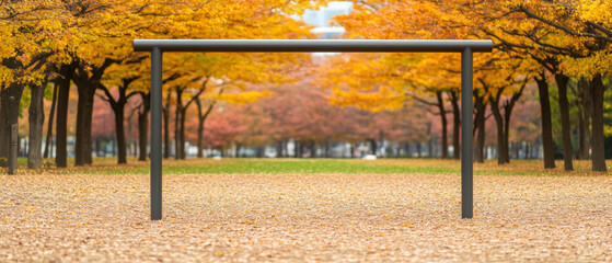 Obraz premium playground gym frame stands in city park surrounded by vibrant autumn trees, creating serene and inviting atmosphere for outdoor activities