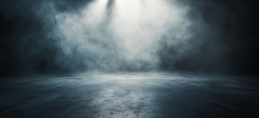 A spotlight shines through swirling smoke and mist onto a dark concrete floor.