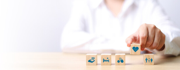 Health insurance concept. healthcare medical wooden cube block with icon, health and access to...