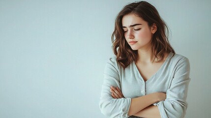 Fototapeta premium Young Woman in Thoughtful Pose Against Plain Background