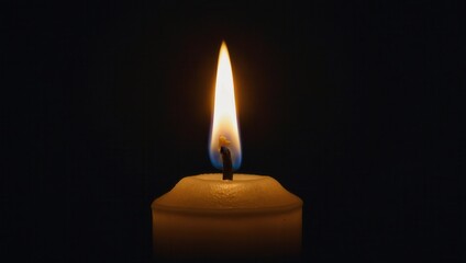 Lit candle softly glowing in center against a dark peaceful background