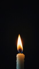 Black and white photo of single candle glowing against gradient background