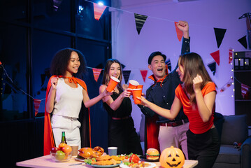 Halloween party with friends in costumes, enjoying drinks, food, and festive decorations. Perfect for autumn gatherings