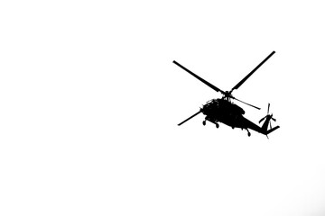 Blackhawk Helicopter Silhouette Against a White Sky