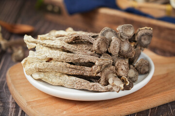 dried lyophyllum decastes on wooden table.
