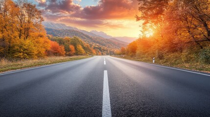 Fototapeta premium Black asphalt road landscape at sunset in beautiful colorful nature. Highway scenery among mountains in autumn season. 