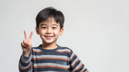 Asian boy with two fingers hand sign