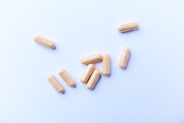 Lutein capsules. Dietary supplement on bright background. Soft focus. Top view. Close up. Copy space.	