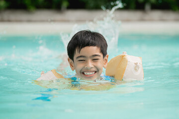 boy playing in the pool